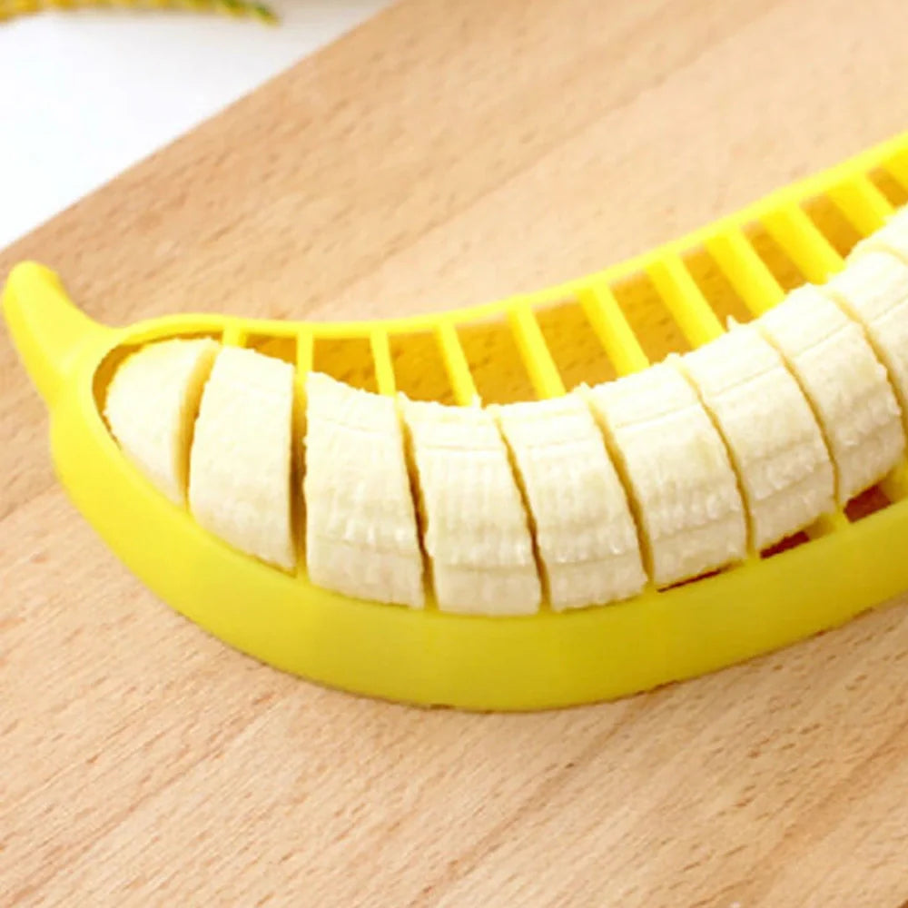 Yellow food grade PP banana cutter, 25 cm long, slices entire fruit in one quick motion for easy kitchen prep