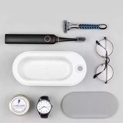 USB-powered glasses and watch cleaning device in dark green, pink, or white