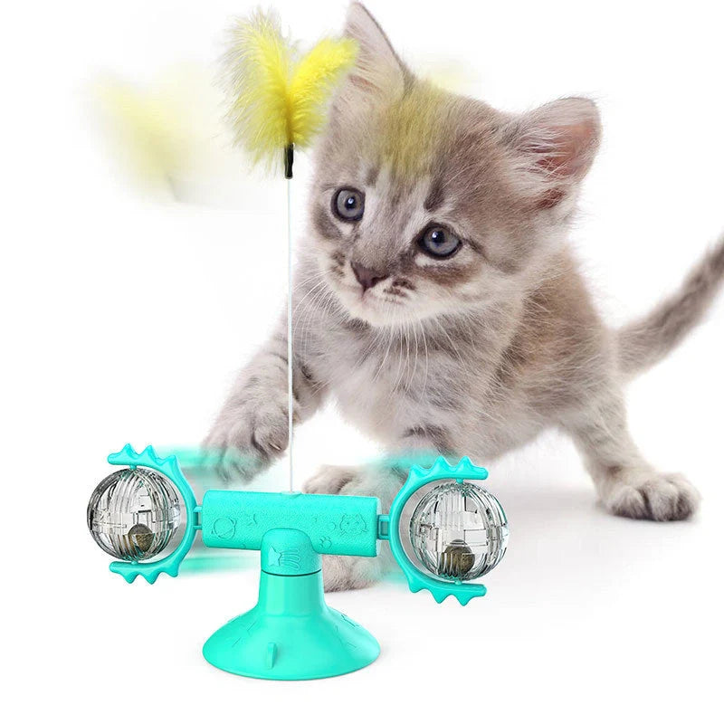 Cat playing with rotating windmill toy featuring suction base and luminous ball