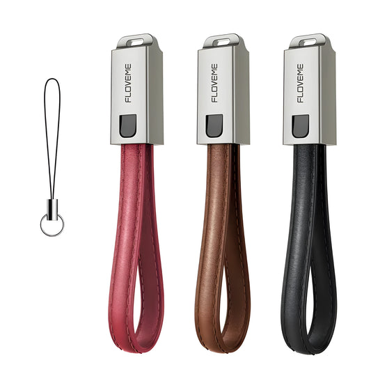 Short black leather iPhone charging cable with metal connector next to a power bank