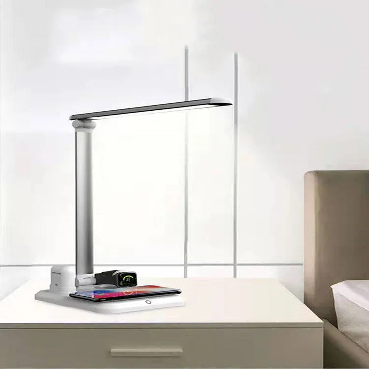 Black and white 4-in-1 LED desk lamp with wireless charging pad and Bluetooth speaker