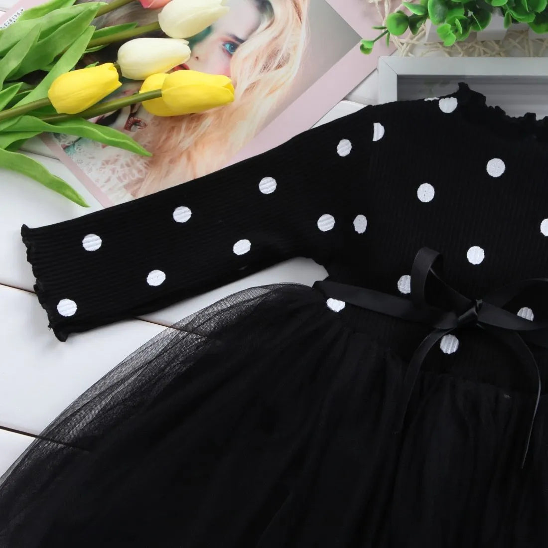 Baby girl's long sleeve black tutu lace dress with lace trim, shown on a hanger.