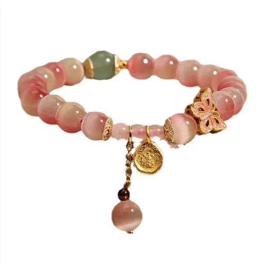 Women's butterfly bracelet featuring genuine opal stones in a pink colour palette with electroplated metal accents, designed for everyday wear with Chinese-style detailing and secure fastening for comfortable fit.