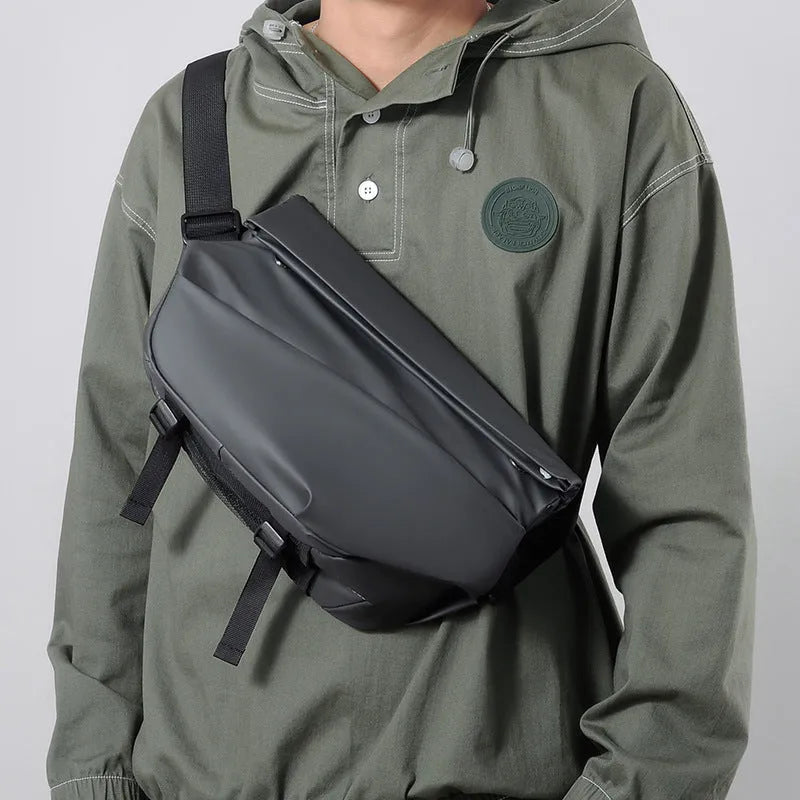 Grey crossbody bag with single shoulder strap showing zipper opening and internal organisation pockets