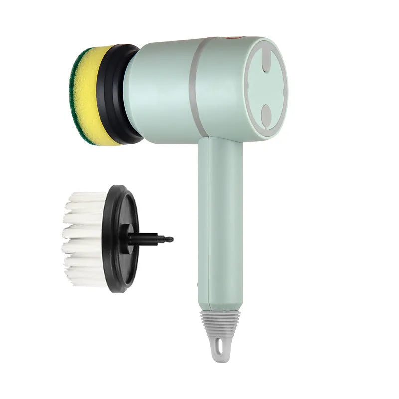 Green electric cleaning brush with scouring pad and brush heads on a kitchen worktop.