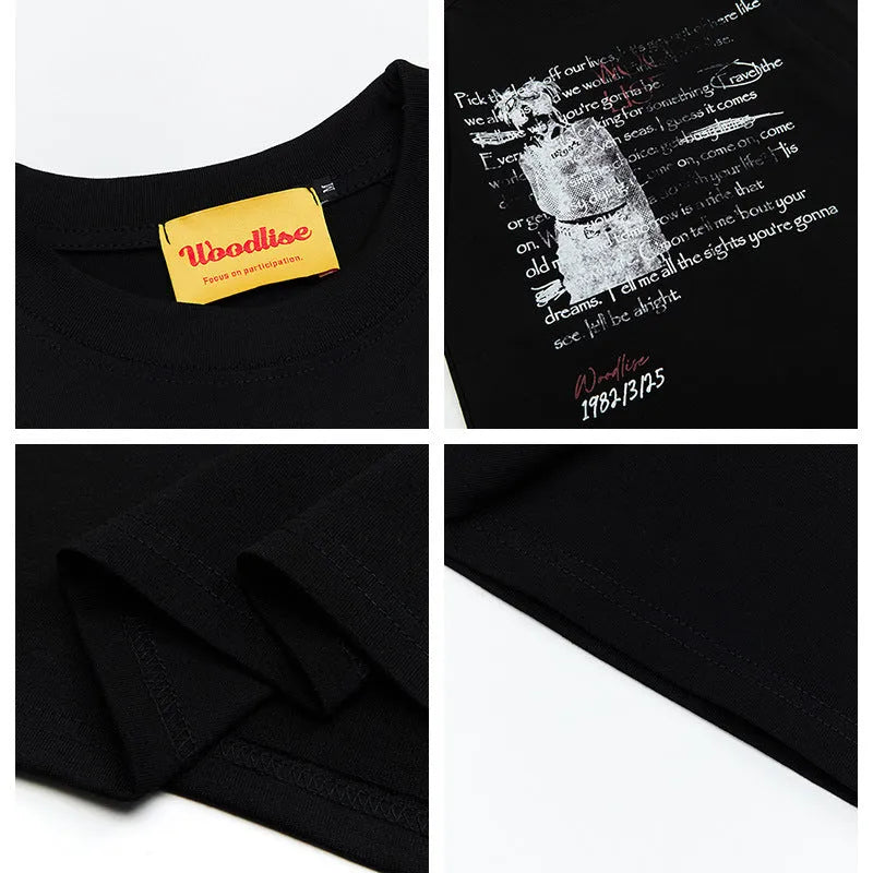 Man wearing a black loose-fit pure cotton t-shirt with a white letter print and short raglan sleeves.