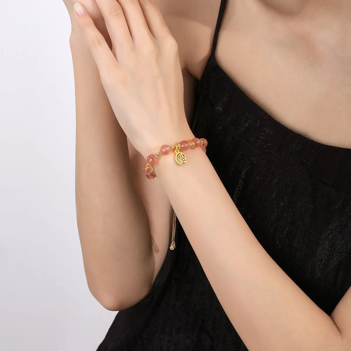 Strawberry quartz bracelet with gold electroplated metal and engraved fu character geometric jewellery design