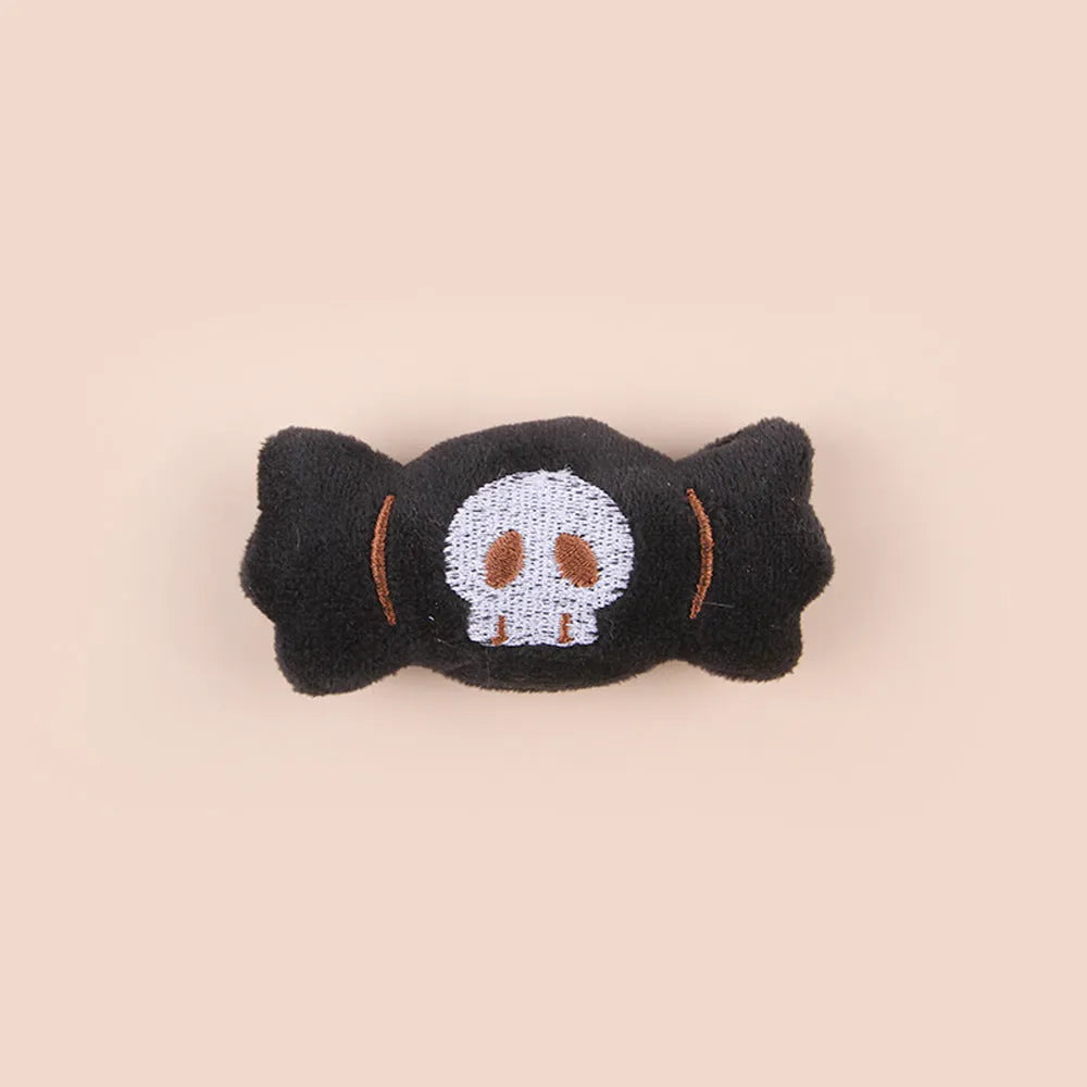 Plush cat teaser wand with candy, eyes, and skull heads on a 40cm string next to a wand handle.