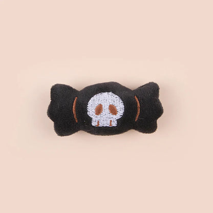 Plush cat teaser wand with candy, eyes, and skull heads on a 40cm string next to a wand handle.