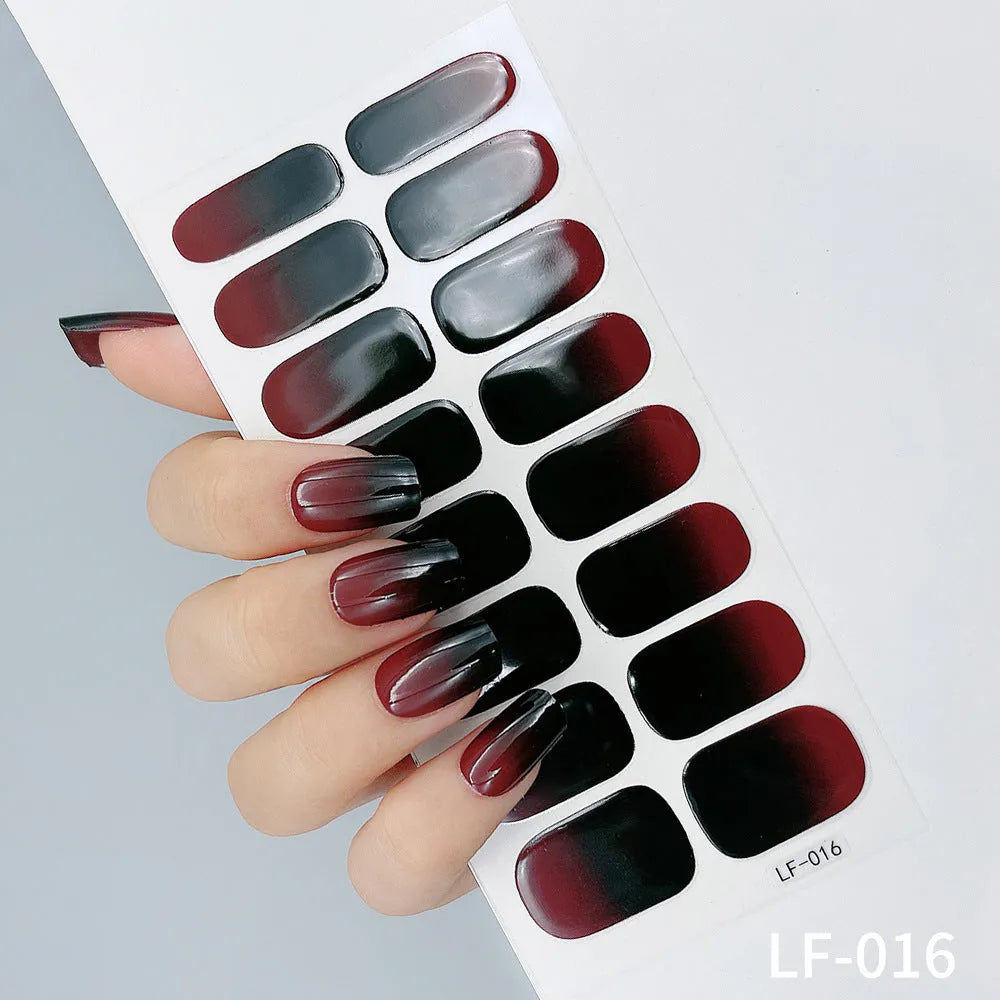 Sheet of 16 small design nail art stickers including cross, rose, tulip and marble patterns.