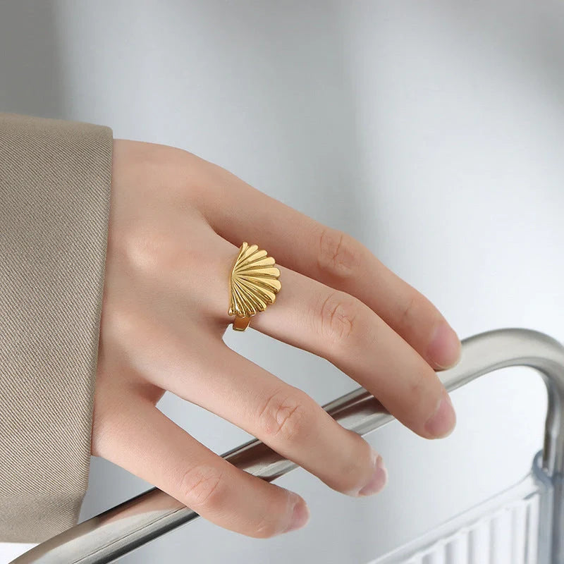 Elegant scallop-inspired titanium steel ring in steel or gold finish, available in sizes 6, 7, and 8, featuring a unique geometric design for a stylish and versatile accessory.
