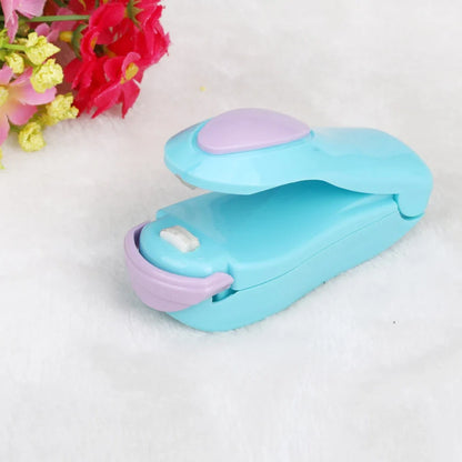 Mini hand pressure heat sealing machine measuring 10cm with magnetic base for plastic bag food preservation