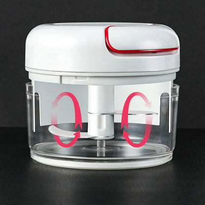 White manual food chopper with stainless steel blades on a kitchen countertop.