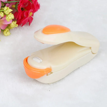 Mini hand pressure heat sealing machine measuring 10cm with magnetic base for plastic bag food preservation
