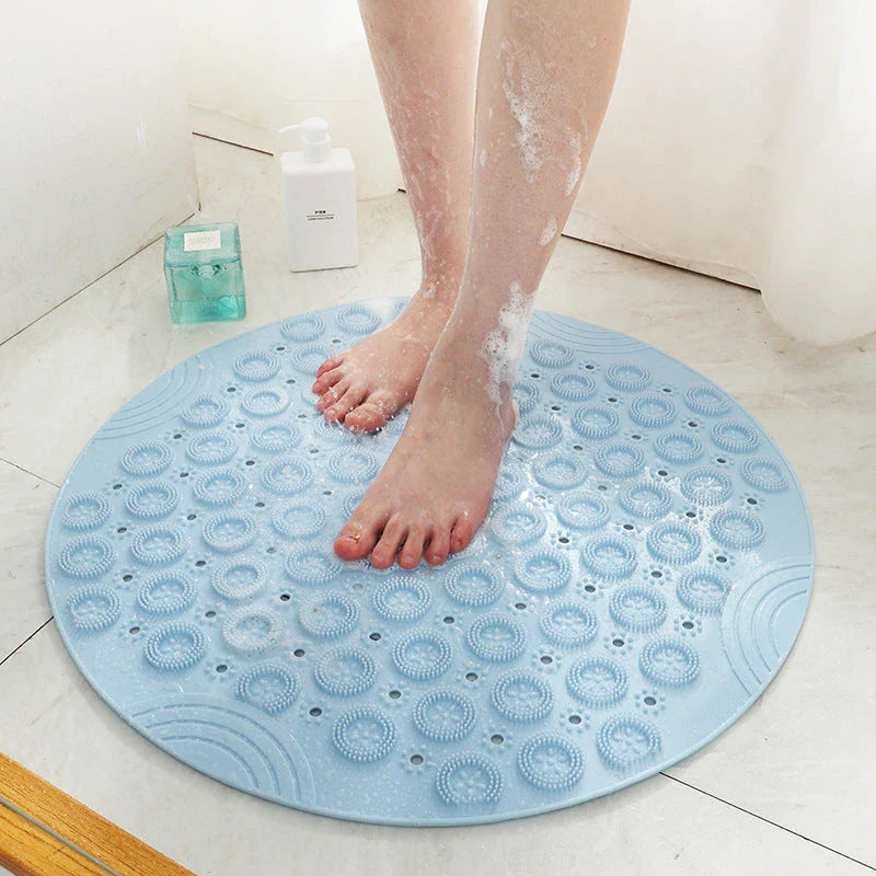 Textured round shower mat with anti-slip surface, massage nodules, and drainage holes for a comfortable and safe bathing experience