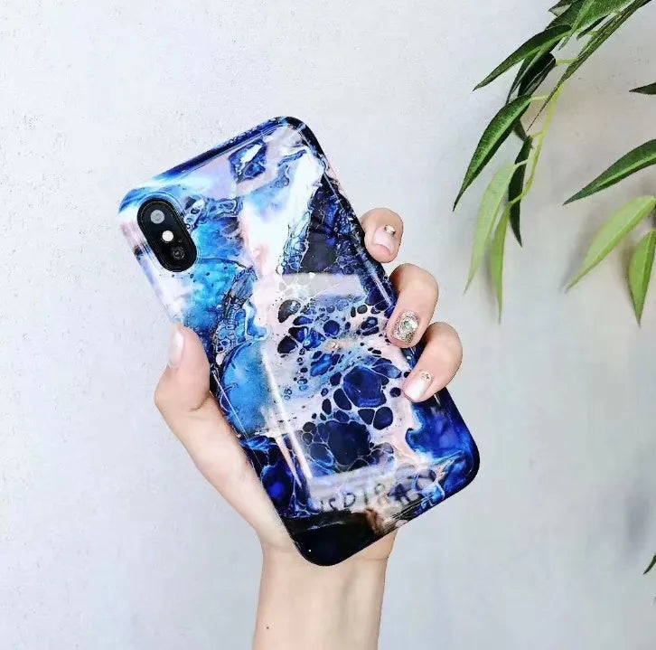 Colourful stone pattern soft back phone case for iPhone on a table.