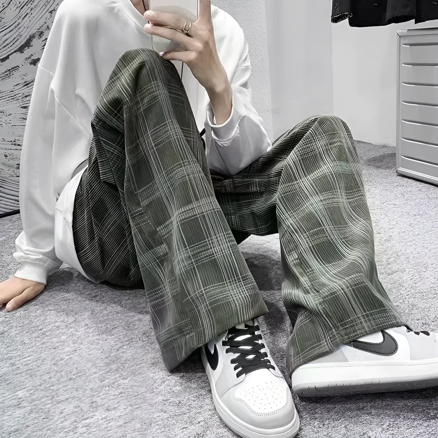 Men's black and green plaid straight leg trousers showing mid-waist design and six size options
