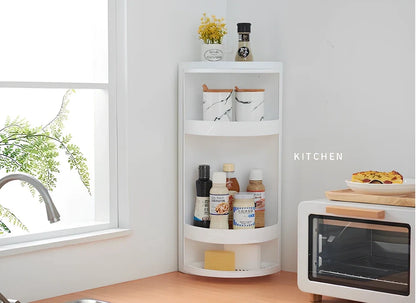 White triangle corner shelf with three tiers mounted in bathroom corner holding toiletries