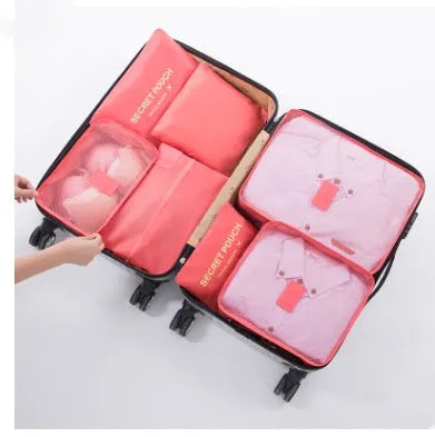 Set of six coloured nylon packing cubes and flat pouches for travel organisation.