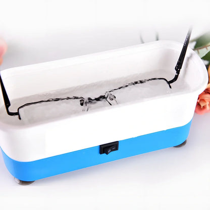 Blue analog ultrasonic cleaner measuring 17x6x8cm with contact lens box and battery compartment