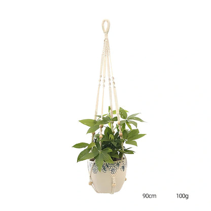 Hand-knitted cotton flowerpot net bag showing mesh pattern and hanging installation