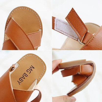 Children's black cross-strap sandals with adjustable Velcro fastening showing size range 21-30