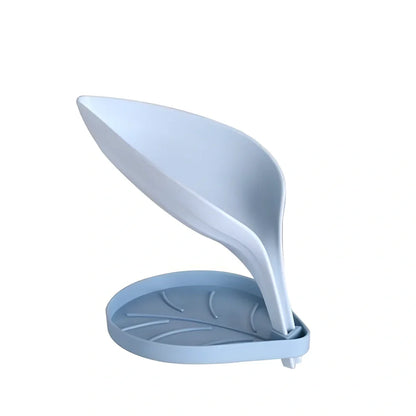 Blue bathroom soap dish with tree texture pattern and drainage channels on white ceramic sink