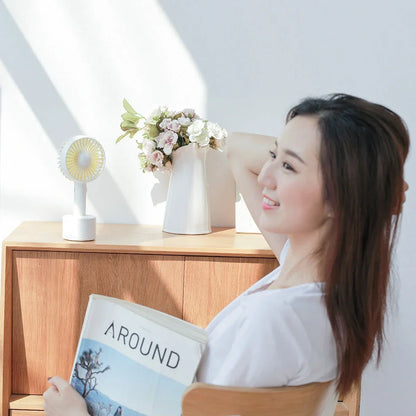 Blue shaking head handheld fan showing oscillating mechanism and USB charging port