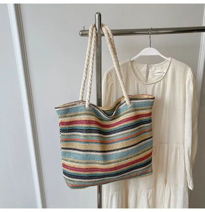 Blue straw-woven nylon shoulder bag with a single strap and large compartment.