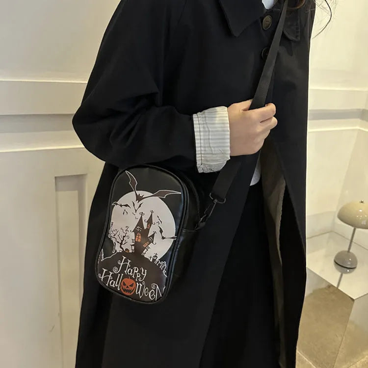 Halloween graffiti print crossbody bag in black with pumpkin, ghost, and bat designs, measuring 14x23x9.5cm