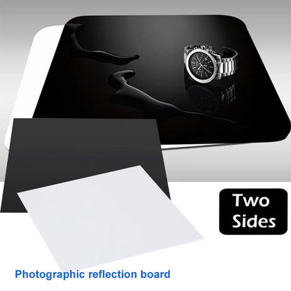 Square black and white acrylic reflection boards for product photography on a table