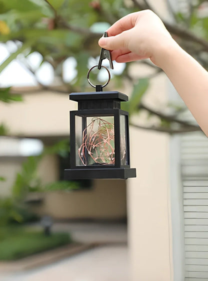 Black solar candle lamp with warm white LED illumination for outdoor gardens and patios