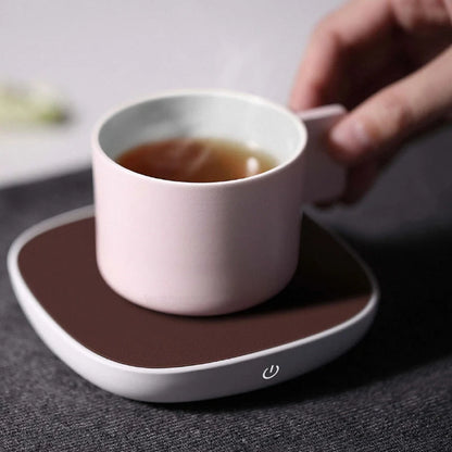 White 12V safety voltage heated base heating coaster on a wooden table