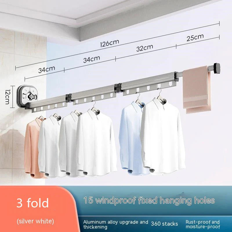 Aluminum retractable drying rack mounted on a window, extending outward for clothes drying