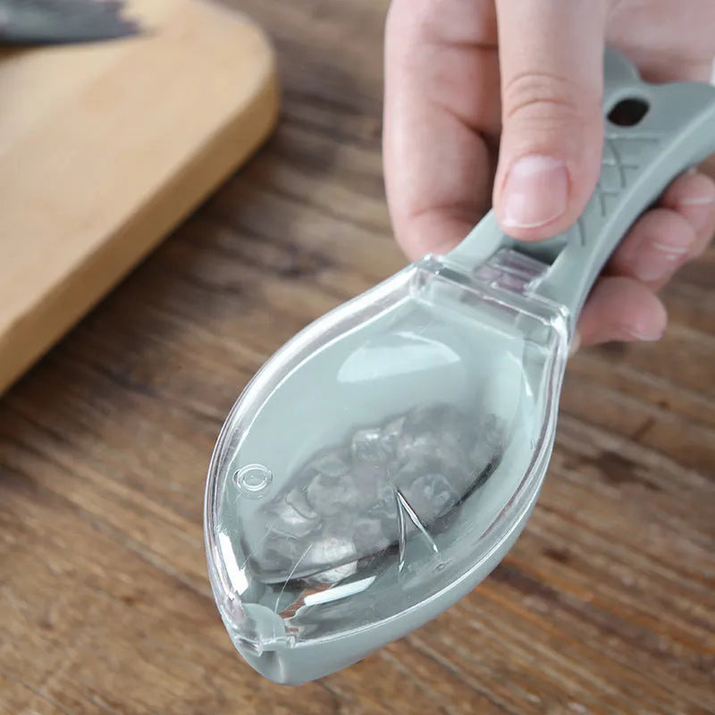 Fish scaler with fish-shaped handle and integrated scale cover for kitchen fish preparation