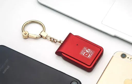 Bluetooth dual SIM adapter with keychain for GSM networks providing dual standby call and SMS functionality via iOS app with lost alarm and address book sync on black leather blue orange red colour options