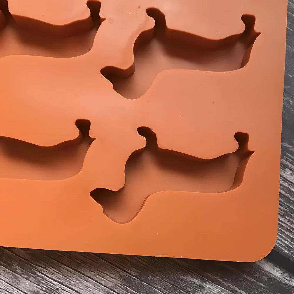 Orange silicone ice mould with 12 animal-shaped compartments for making decorative ice cubes