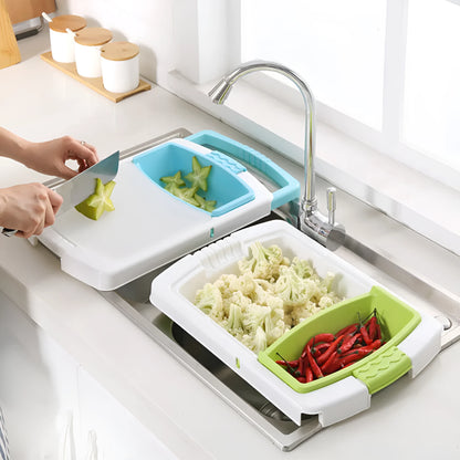 Green multifunction cutting board with drainage holes and storage trough mounted on a kitchen sink.