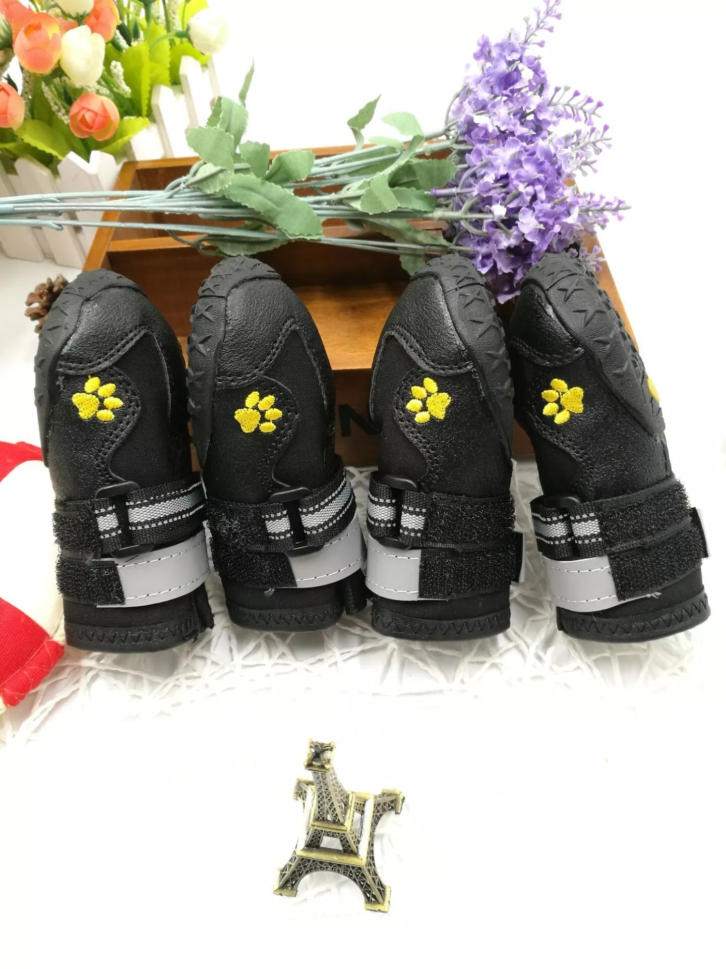 Black waterproof dog shoes with non-slip soles and adjustable fuzzy belts