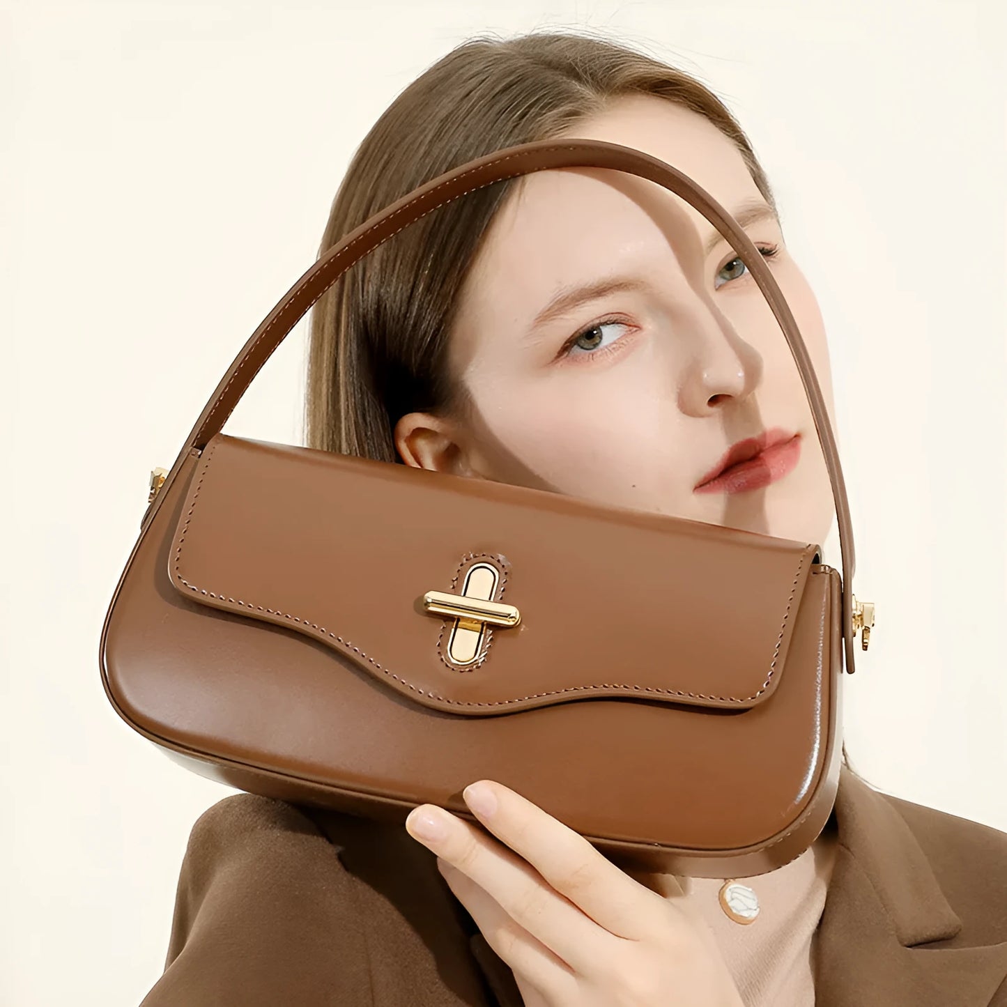 Genuine leather baguette handbag in clamshell design with internal organiser compartments