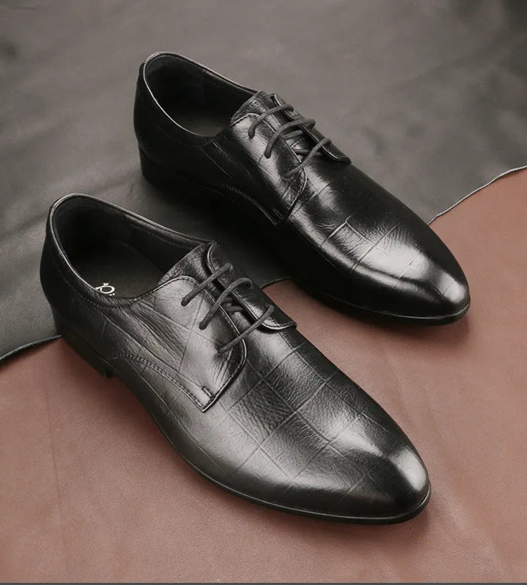 Men's black leather derby shoes with pointed toe, visible sewing details, and antiskid rubber soles