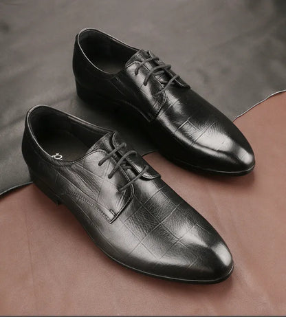 Men's black leather derby shoes with pointed toe, visible sewing details, and antiskid rubber soles