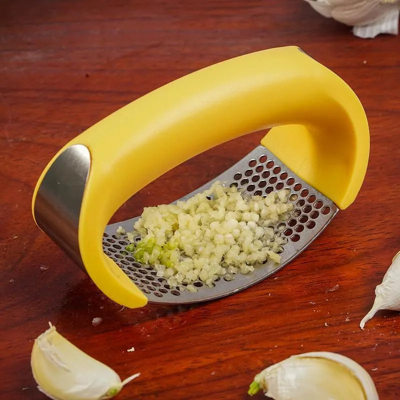 Stainless steel garlic press with ergonomic handle in kitchen setting