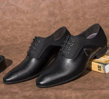 Men's black Oxford shoes with a polished PU upper and durable rubber sole on a wooden floor.