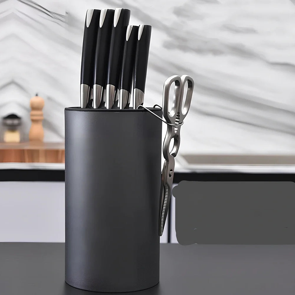 White wave pattern knife holder with integrated scissors hook storing multiple kitchen utensils