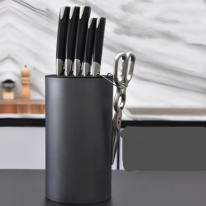 White wave pattern knife holder with integrated scissors hook storing multiple kitchen utensils