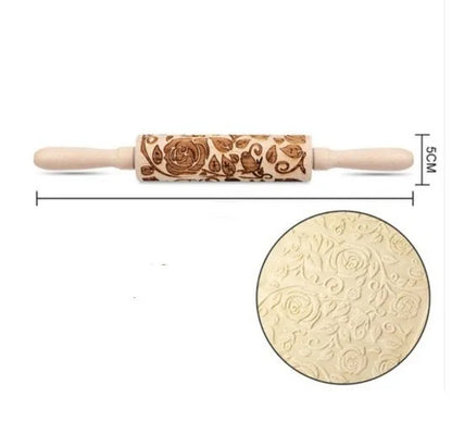 Wooden rolling pin with engraved Christmas patterns including reindeer and snowflakes on a 45cm long barrel.