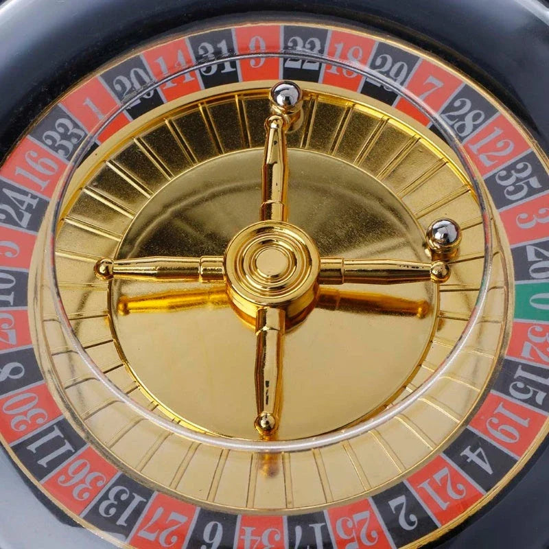 Electric casino-style roulette drinking game set with spinning wheel, shot glasses, and steel balls