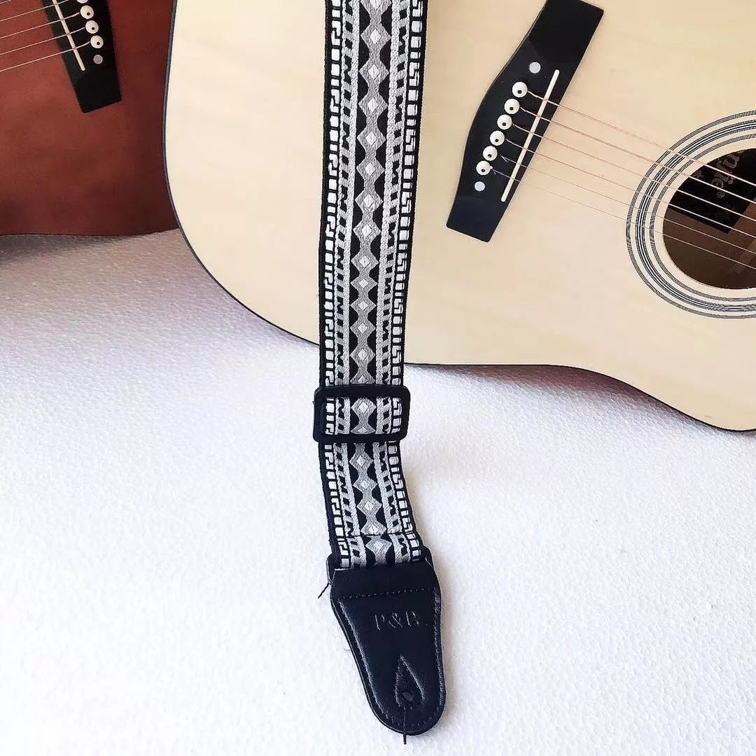 Adjustable embroidered guitar strap with durable webbing and intricate design
