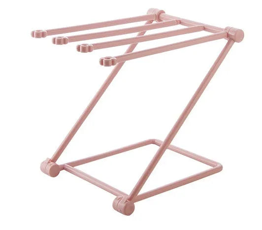 Foldable plastic dishcloth shelf organiser in Nordic style mounted on a kitchen wall